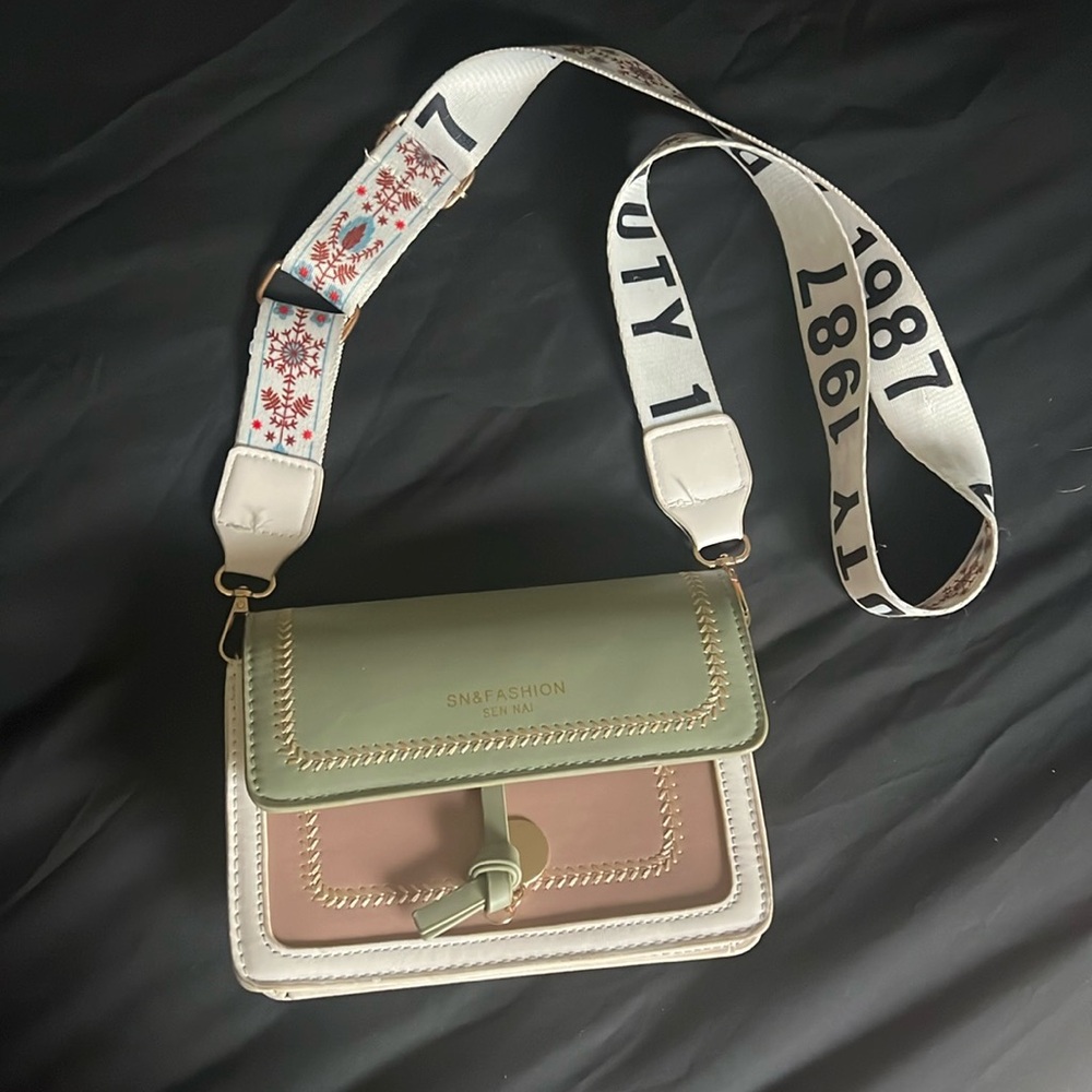Green, brown and white snap purse with adjustable strap.